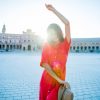 Elegant woman dancing in front of Plaza de Espana, Sevilla